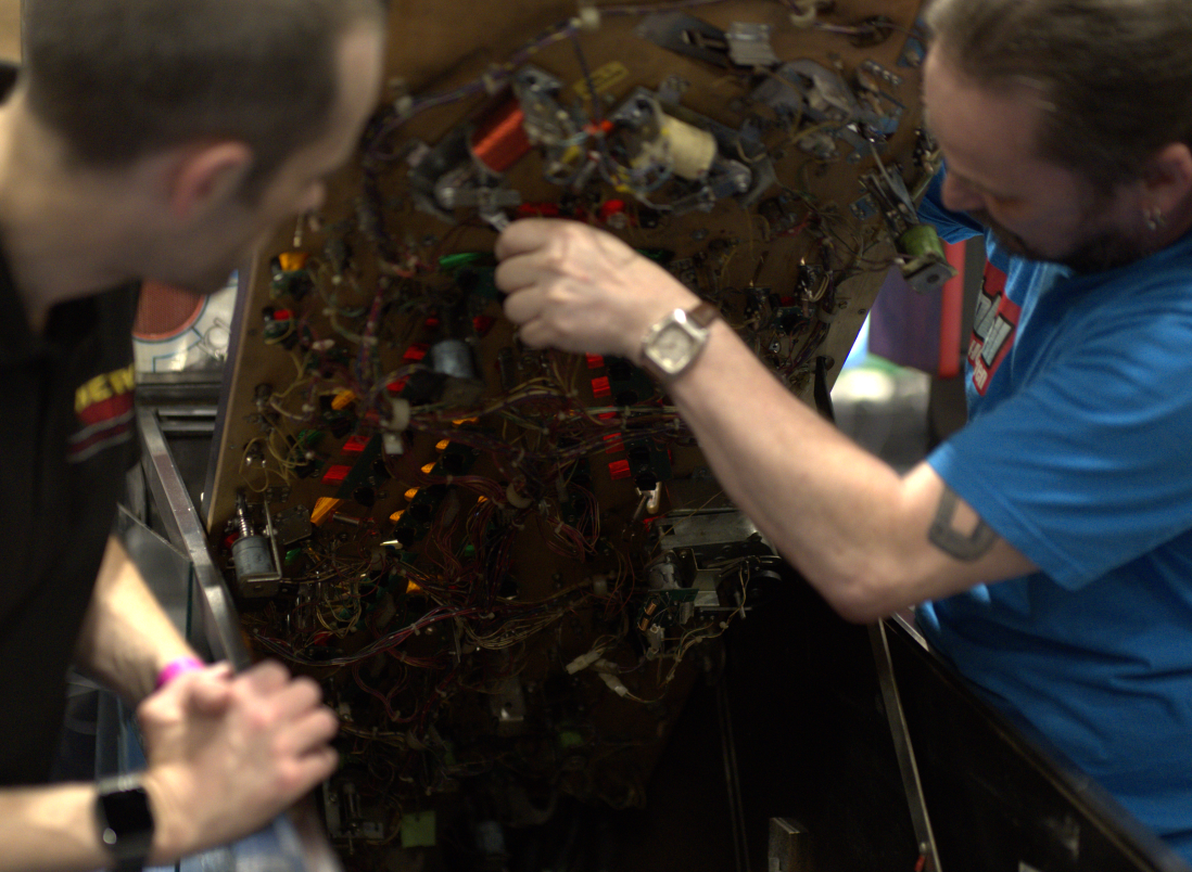 Repair work being performed on a pinball machine
